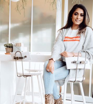 sumona seth sitting on a stool in an office